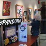 June 2008 The lobby/art gallery. Bruce bought lights and hanging rails to transform the institutional lobby into a popup art gallery. Here some folks from the Pandora Art Collective are hanging their work.