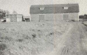 old black and white photo of barn and field