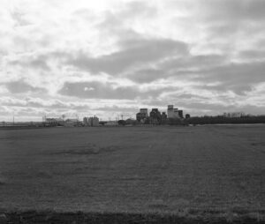 black and white photo of typical small prairie town with grain elevators