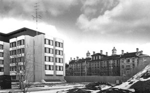 1970s black and white photo showing modern institutional building on the left and old 19th century institutional structure on the right