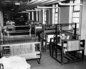 weaving looms set up in large studie