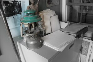 photo of green lantern on office desk with paperwork