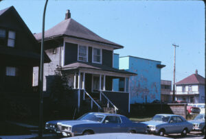 old house with cars parked in front