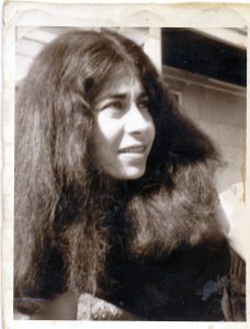 head and shoulders of young woman with mass of long dark hair