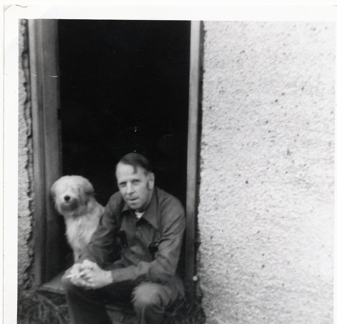 man and dog sitting on door step