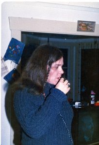 woman with long dark hair in living room
